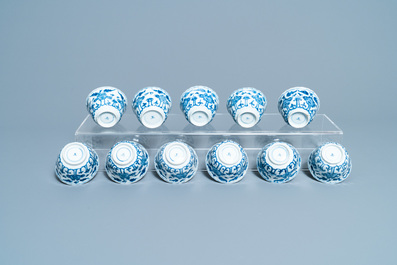 Seventeen Chinese blue and white cups and twenty-two saucers with floral design, Kangxi