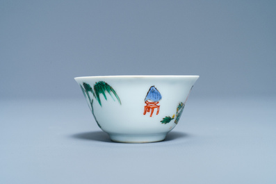 A Chinese famille verte 'erotical subject' cup and saucer, Kangxi