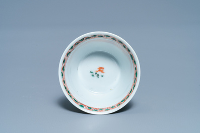 A Chinese famille verte 'erotical subject' cup and saucer, Kangxi
