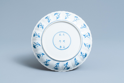 A Chinese blue and white 'erotical subject' plate, Chenghua mark, Kangxi