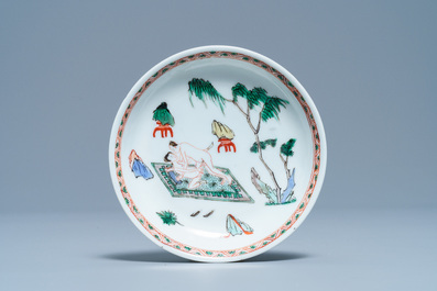 A Chinese famille verte 'erotical subject' cup and saucer, Kangxi