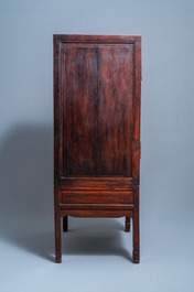 A Chinese hongmu cupboard with a blue and white 'Buddhist lions' plaque, 19th C.