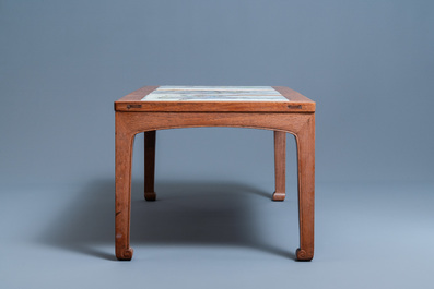 A Chinese wooden table with three qianjiang cai plaques, 19/20th C.