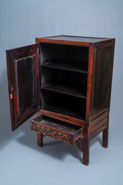 A Chinese hongmu cupboard with a blue and white 'Buddhist lions' plaque, 19th C.