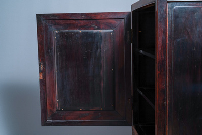 A Chinese hongmu cupboard with a blue and white 'Buddhist lions' plaque, 19th C.