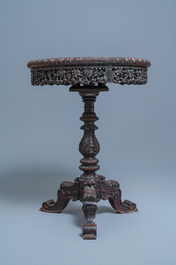 A Chinese carved wooden table with a large Canton famille verte plaque, 19th C.