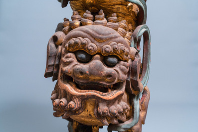 Two Chinese gilded and polychromed wooden colon fragments with Buddhist lions, 18/19th C.