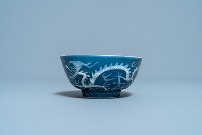 A Chinese white slip-decorated blue-ground 'dragon' bowl, Yu Tang Jia Qi mark, Wanli