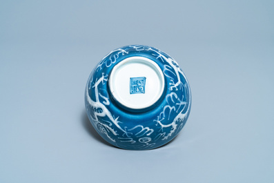 A Chinese white slip-decorated blue-ground 'dragon' bowl, Yu Tang Jia Qi mark, Wanli