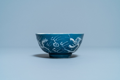 A Chinese white slip-decorated blue-ground 'dragon' bowl, Yu Tang Jia Qi mark, Wanli