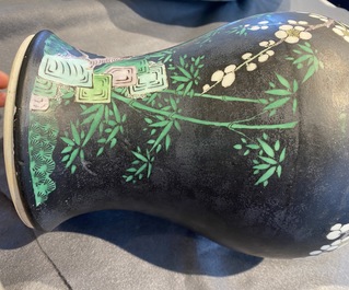 A Chinese famille noire 'magpie and prunus' yenyen vase, Kangxi