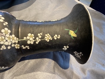 A Chinese famille noire 'magpie and prunus' yenyen vase, Kangxi