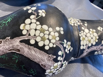 A Chinese famille noire 'magpie and prunus' yenyen vase, Kangxi