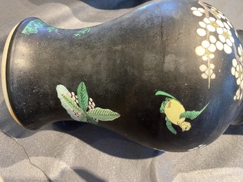 A Chinese famille noire 'magpie and prunus' yenyen vase, Kangxi
