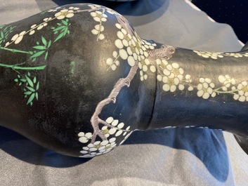 A Chinese famille noire 'magpie and prunus' yenyen vase, Kangxi