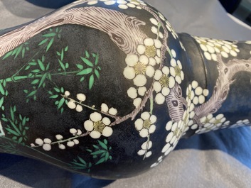 A Chinese famille noire 'magpie and prunus' yenyen vase, Kangxi
