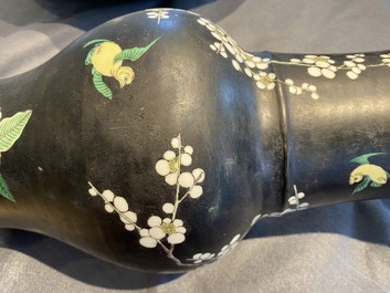 A Chinese famille noire 'magpie and prunus' yenyen vase, Kangxi