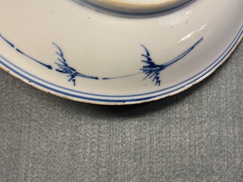 A Chinese blue, white and copper red saucer dish with floral design, Kangxi