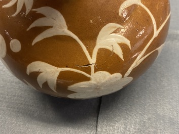 A rare Chinese slip-decorated brown-ground Swatow kendi, Ming
