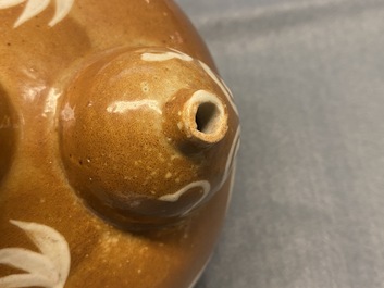 A rare Chinese slip-decorated brown-ground Swatow kendi, Ming