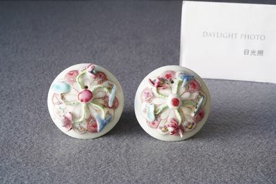 A pair of Chinese famille rose relief-decorated teapots and covers, Yongzheng