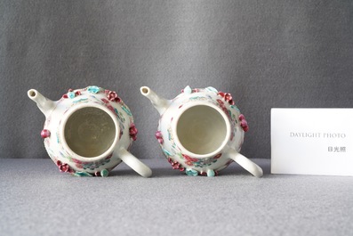 A pair of Chinese famille rose relief-decorated teapots and covers, Yongzheng