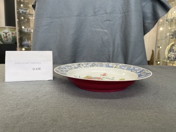 A Chinese famille rose 'ruby back' plate with a bird on a blossoming branch, Yongzheng
