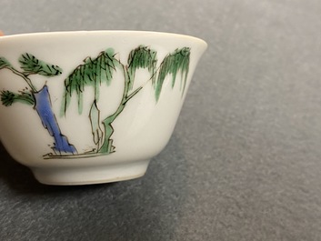 A Chinese famille verte 'erotical subject' cup and saucer, Kangxi