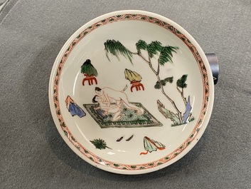 A Chinese famille verte 'erotical subject' cup and saucer, Kangxi