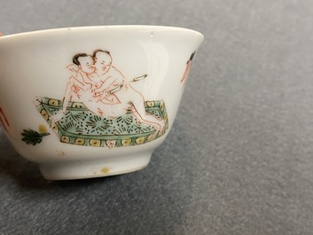 A Chinese famille verte 'erotical subject' cup and saucer, Kangxi