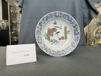 A Chinese famille rose 'ruby back' plate with a bird on a blossoming branch, Yongzheng