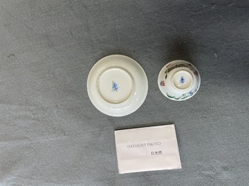 A Chinese famille verte 'erotical subject' cup and saucer, Kangxi