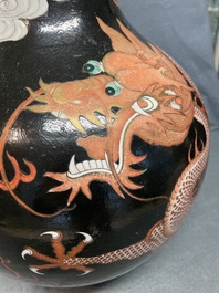 A Chinese famille noire 'dragon' bottle vase, 19th C.