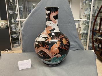 A Chinese famille noire 'dragon' bottle vase, 19th C.