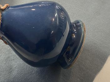 A Chinese monochrome blue garlic head vase with applied biscuit dragon, Jiajing