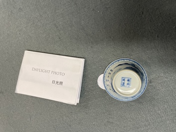 A Chinese blue and white inscribed wine cup, Kangxi