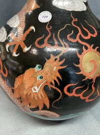 A Chinese famille noire 'dragon' bottle vase, 19th C.