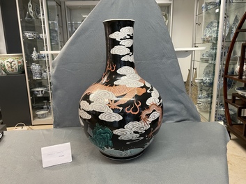 A Chinese famille noire 'dragon' bottle vase, 19th C.