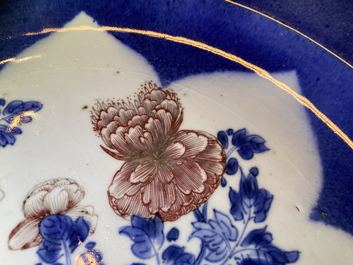 A Chinese blue, white and copper red powder blue-ground charger, Kangxi