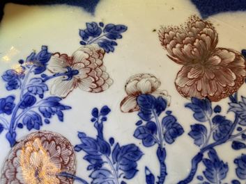 A Chinese blue, white and copper red powder blue-ground charger, Kangxi
