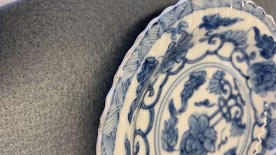 Seventeen Chinese blue and white cups and twenty-two saucers with floral design, Kangxi