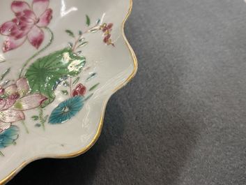 A Chinese famille rose 'lotus' cup and saucer with applied design, Yongzheng