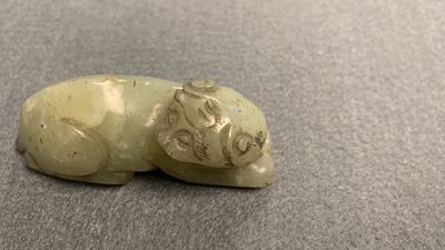 Five Chinese celadon and russet jade carvings, 19th C.