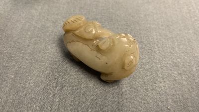 Five Chinese celadon and russet jade carvings, 19th C.