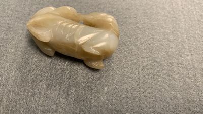 Five Chinese celadon and russet jade carvings, 19th C.