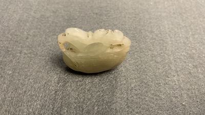 Five Chinese celadon and russet jade carvings, 19th C.