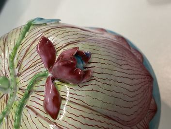Een Chinese famille rose lotusvormige kop en schotel met reli&euml;fdecor, Yongzheng