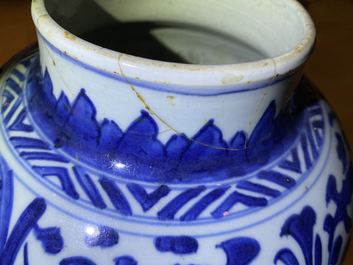 A pair of Chinese blue and white 'lotus scroll' vases and covers, Kangxi