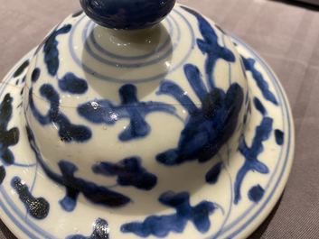 A pair of Chinese blue and white 'lotus scroll' vases and covers, Kangxi