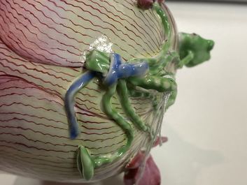 Een Chinese famille rose lotusvormige kop en schotel met reli&euml;fdecor, Yongzheng